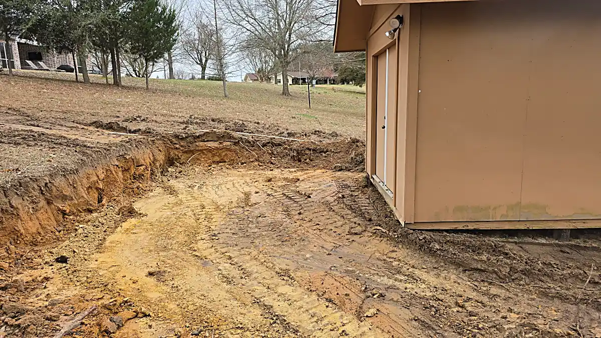 Exact grade trenching for long poured concrete driveway layout