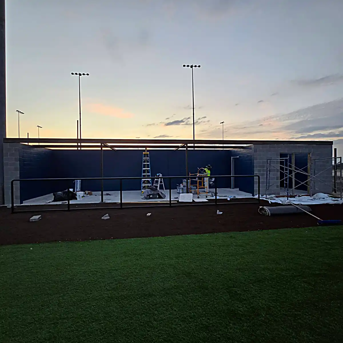 Athletic facility dugout at sunset