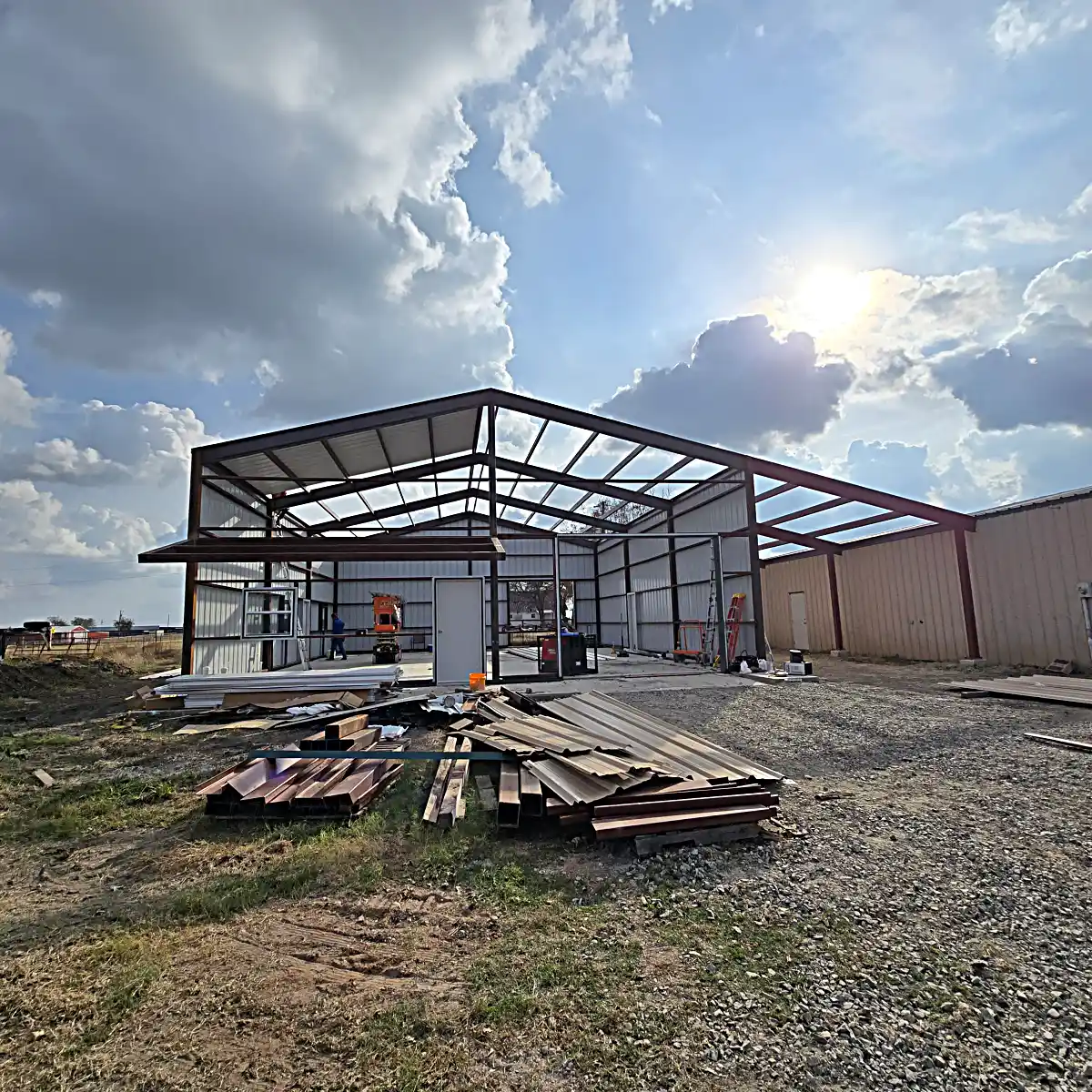 Finished metal building with open covered workspace