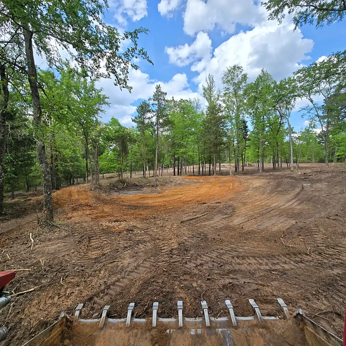 Cleared ground after tree and brush removal on a Mineola, TX lot